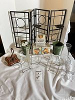 Full lot showing folding screen, vases, planters, stands, photo cubes