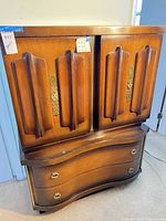 Front view of armoire dresser showing doors and drawers