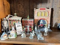 All items together on shelf showing firehouse, pewter figures, ladder truck, and small houses