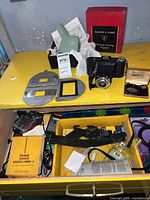 Overall view showing camera, magnifier, negative carriers, lens case, boxes and accessories