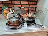 All cookware and utensils grouped on countertop