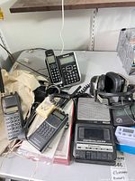 Overall lot view with mixed electronics on tabletop