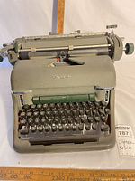 Front angled view showing full typewriter body, keys, carriage and brand name