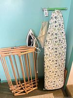Group shot showing drying rack, ironing board, iron, and clothespin bag