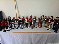 Full group of Byers Choice caroler figurines lined on table