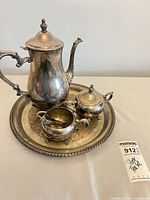 Full view of pot, covered sugar, creamer on tray showing patina and gilded interior