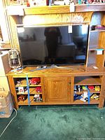 Front view showing full console with hutch, TV opening, base cabinet, side shelves, overall finish and design