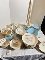 Overhead view of entire dinnerware set showing plates, bowls, cups, saucers, gravy boat, creamer