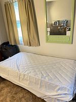 Bed frame with mattress and wall mirror in situ