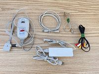 All items laid out: power adapter, DC cable, USB-B cable, RJ11 cable, RCA cable, M305 controller