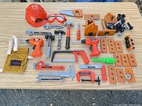 Full layout of all toy tools, fasteners, safety gear and accessories on tabletop