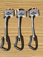 Three Black Diamond Positron quickdraws laid out