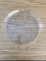 Top view of clear glass plate showing full holly design