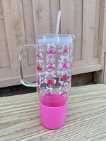 Full side view showing cherry print, handle, pink sleeve