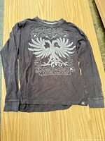 Full view of long sleeve thermal shirt on flat surface