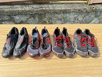 Four pairs of shoes lined on table giving full lot view