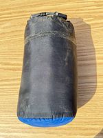 Stuff sack closed, shows wear and buckle closure