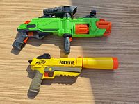 Top view of both blasters on wooden surface