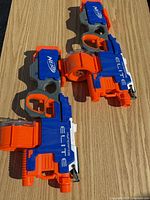 Both HyperFire blasters side by side with drum magazines attached