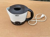 Full view of kettle showing body, handle, dial and cord