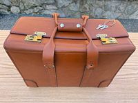 Top view of leather briefcase showing handles and brass locks