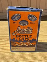Front of orange/blue Jointite box showing trade mark and bottle cap graphics