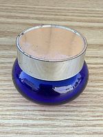 Jar upright with lid on displaying cobalt blue glass and silver plastic lid