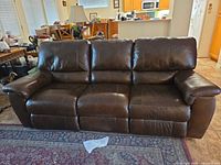Full front view of brown three-seat faux leather sofa