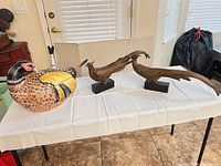 Full view of pheasant tureen with ladle inserted plus both cast metal bird sculptures