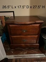 Front view of cherry veneer nightstand showing two drawers and brass-tone pulls