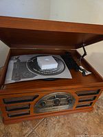 Turntable under lid with tonearm and paperwork