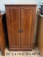 Front view of cabinet with doors closed, dimensions visible