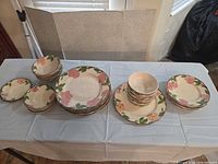 Stacks of dinner plates and bowls on table