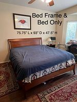 Full view of assembled king sleigh bed frame with mattress in place