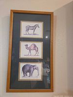Framed print with three animal illustrations in vertical arrangement