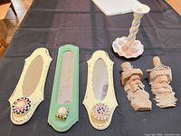 Group shot showing candlestick, three wall hooks and pair wood carvings