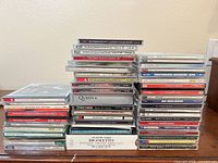 Overall view of three stacks of CDs on wooden surface