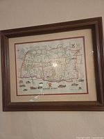 Framed map print in brown wood frame under glass