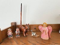 front view of all five wooden figurines