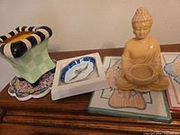 Overall lot showing planter, dish, Buddha, and tiles