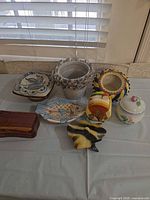 Overall view of eight assorted ceramic, porcelain, and wood items