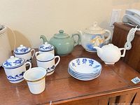 Assorted tea set pieces displayed on table
