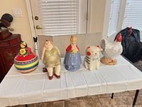 Group shot of five ceramic cookie jars on table