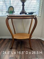 Full view of oak side table with lamp and ceramic plate, dimensions text overlay