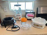 All six kitchen items arranged on countertop