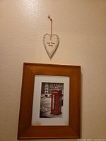 Red telephone booth print below white heart plaque