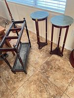 Pair of pedestal tables showing tops and bases