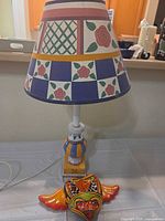 Lamp with shade and wall plaque displayed together
