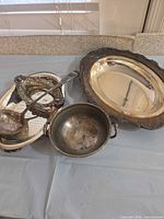 Front view of all five silver-plated pieces showing shapes and relative sizes