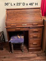 Front view of solid oak roll-top desk with dimensions overlaid